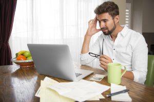 Man reading bad news on the computer screen